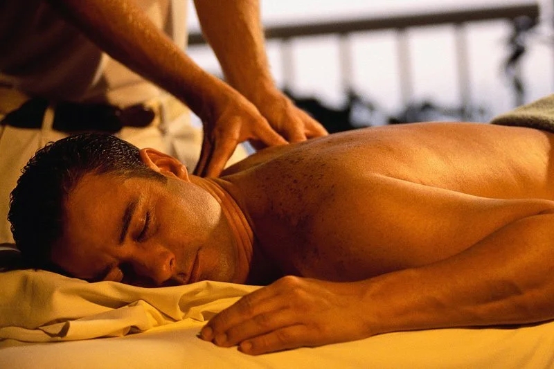 Romantic and relaxing spa ambiance with candles and oils.